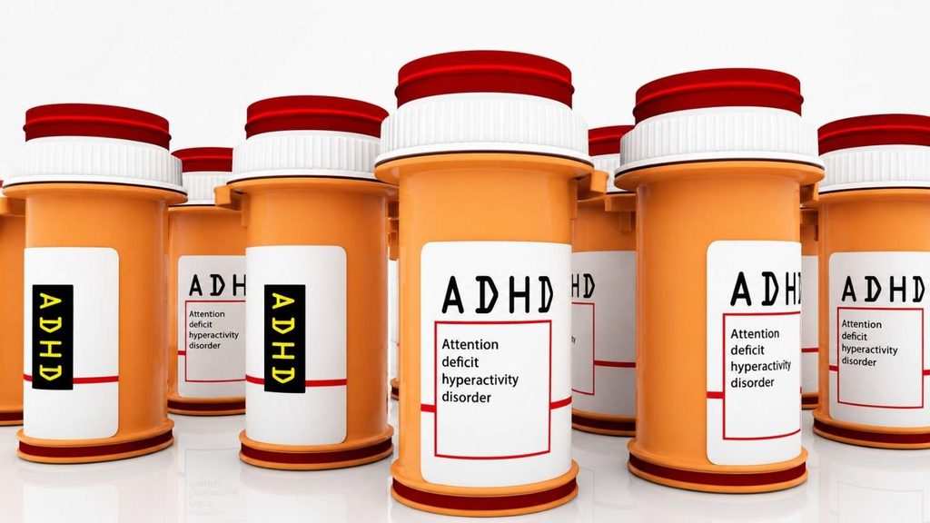Prescription medication bottles representing ADHD treatment options