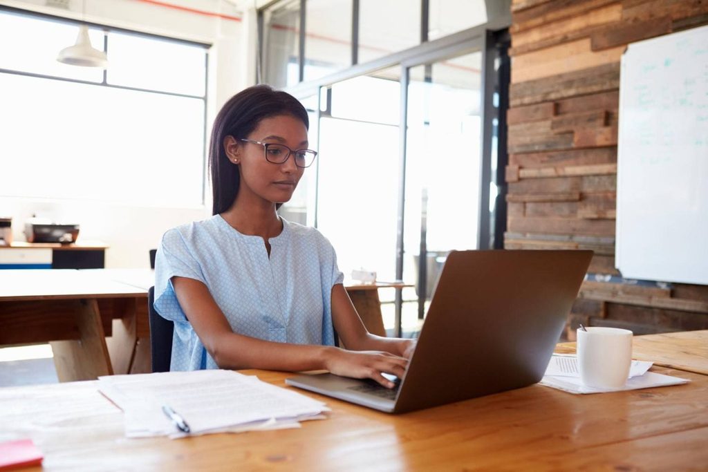 Professional working at a laptop while maintaining focus and alertness