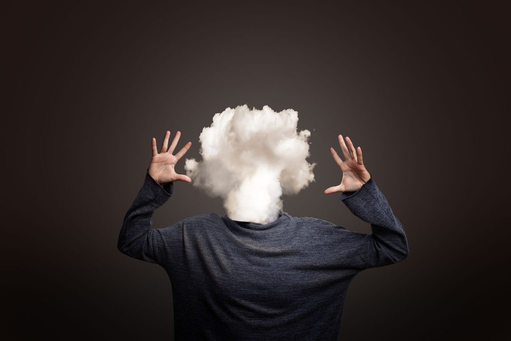 Person experiencing brain fog and difficulty concentrating while working