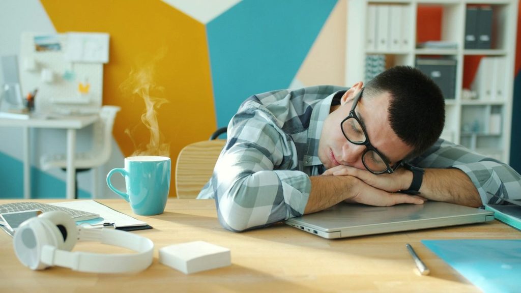Tired person struggling to stay awake during the day, illustrating excessive daytime sleepiness